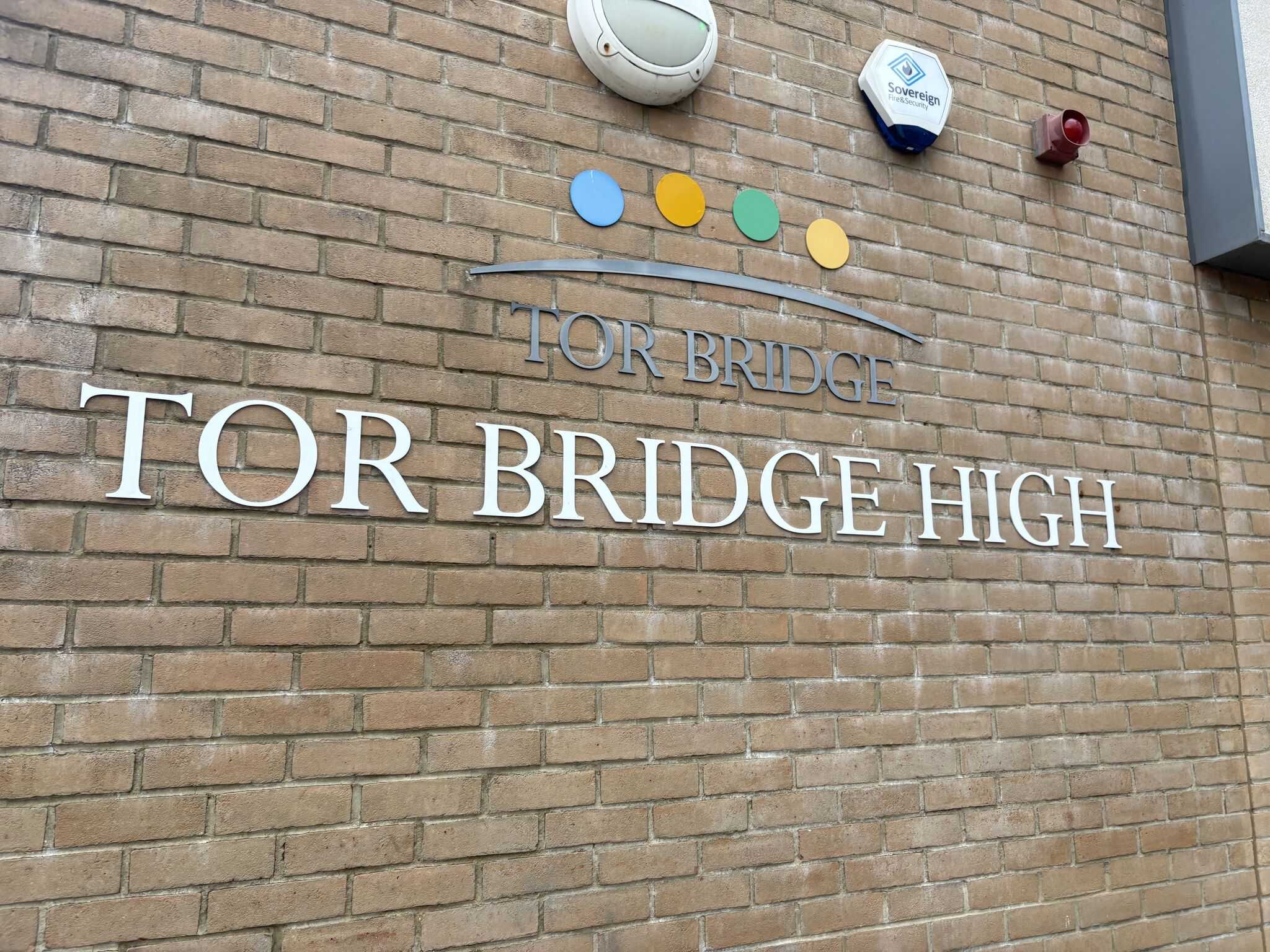 Tor Bridge High school building signage on brick wall